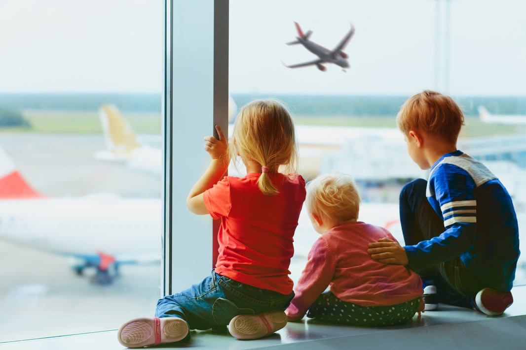 kids waiting for plane in airport, family travel