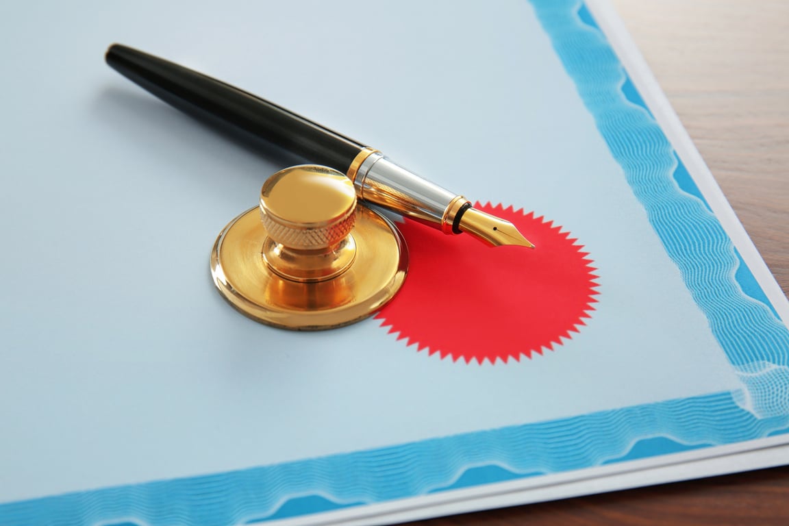 Pen, Stamp and Document on Table